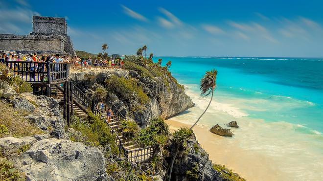 Mayan ruins above the beach with palm in Tulum, Yucatan, Mexico.