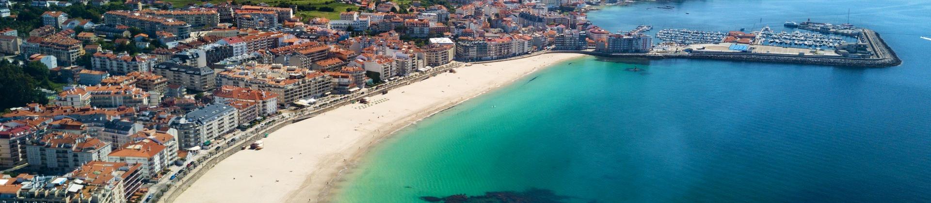 Amazing beach with turquise water in Sanxenxo in partly cloudy weather