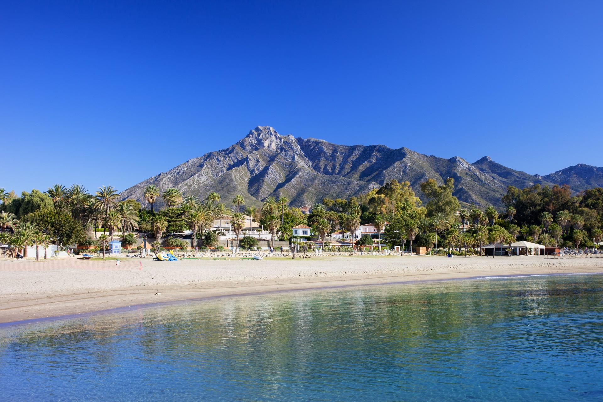 Amazing beach and mountain range in Marbella on a sunny day