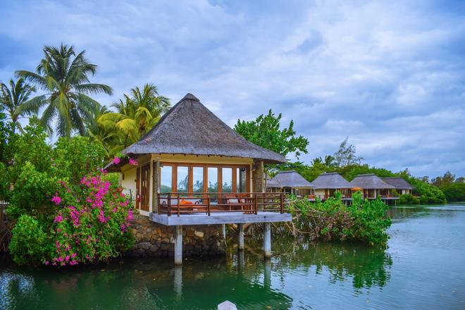 A house located by the sea, next to palm trees in Mauritius