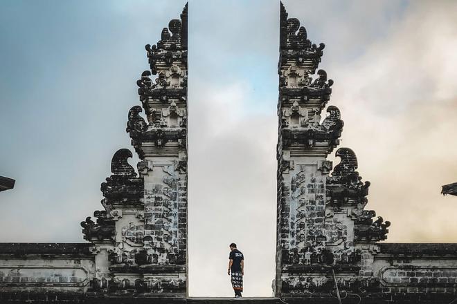 A man standing at the Gateway to Heaven aka Lempuyang Temple