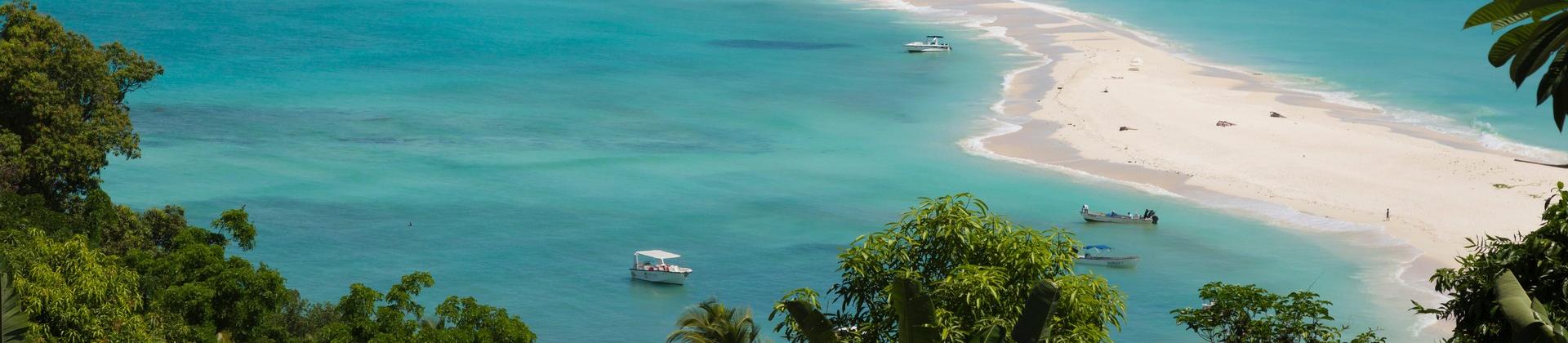 Aerial view of beach in Nosy Be in sunny weather with few clouds