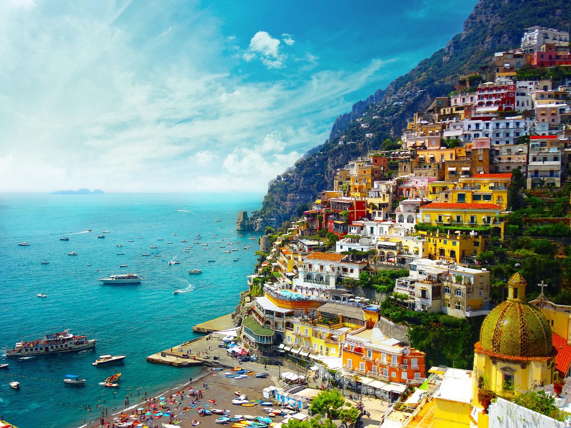 Aerial view of boat in Positano in sunny weather with few clouds