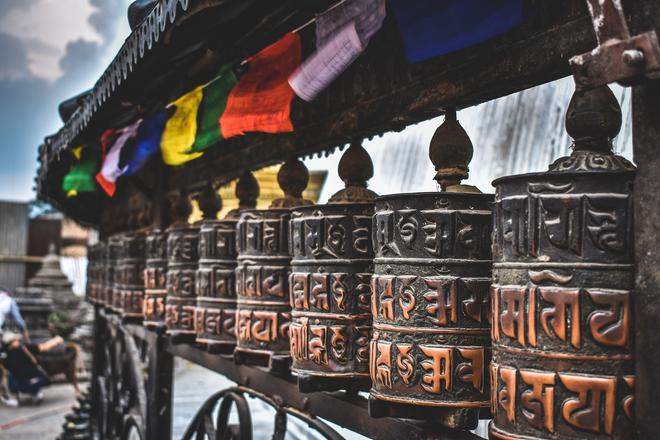 Nepal: prayer mills with coloured flags.