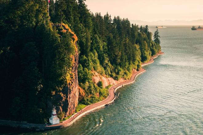 Trees and a road of Stanley Park surrounded by sea in Vancouver