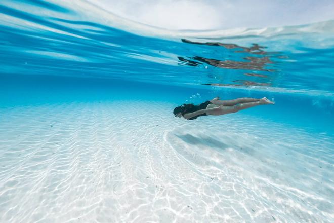 A woman snorkeling in a crystal-clear sea