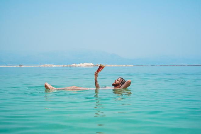 A man reading in a Dead Sea.