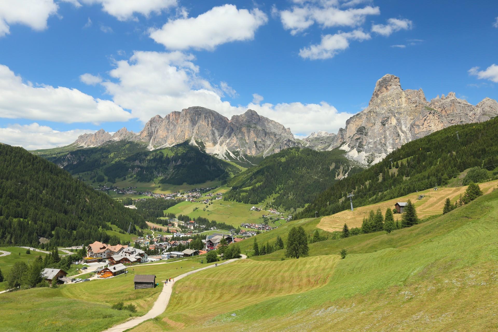 Aerial view of mountain range in Corvara in Badia in sunny weather with few clouds