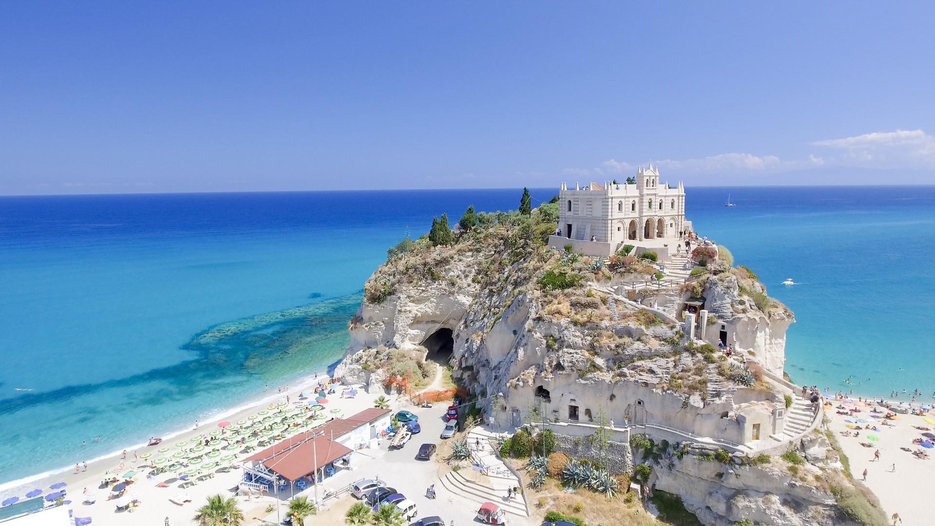 Aerial view of beach in Tropea in partly cloudy weather