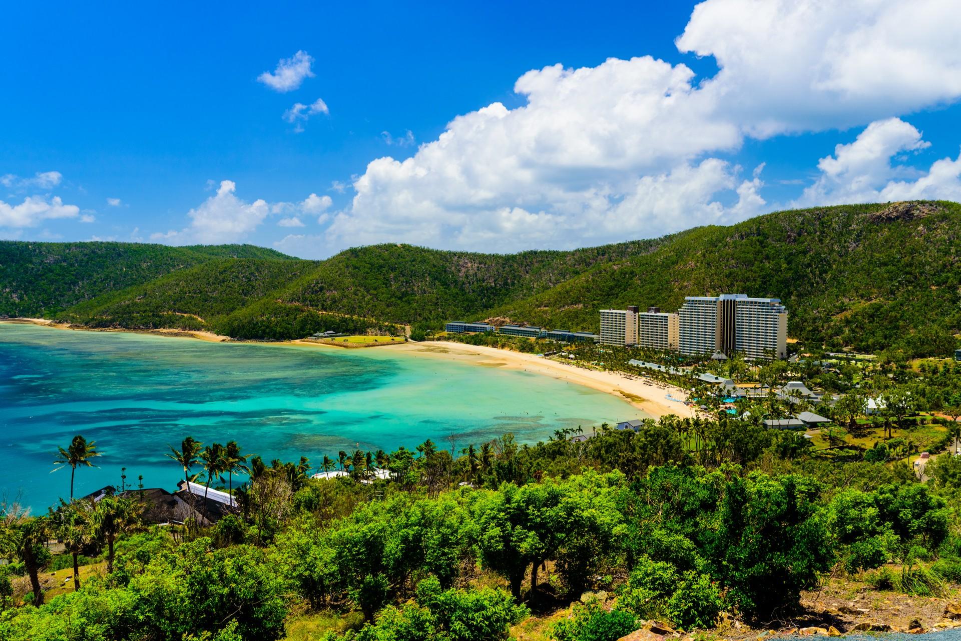 Beach with turquise water in Hamilton Island in sunny weather with few clouds