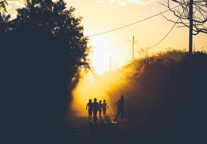 Silhouettes of children in the sun in Madagascar.