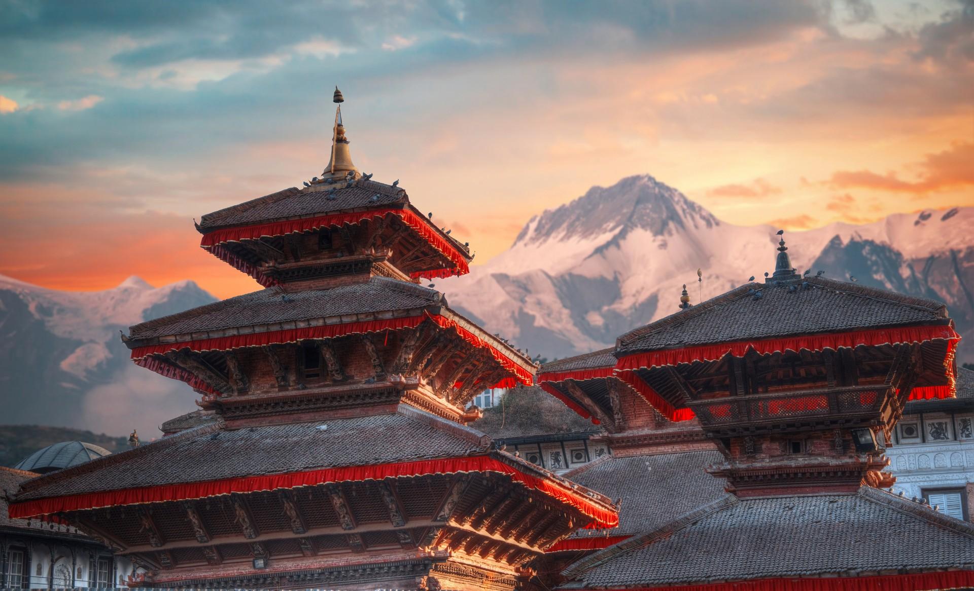 Kathmandu, Nepal: temple with mountains in the background.