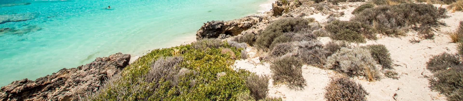 Nice beach by the sea with turquise water in Crete on a clear sky day