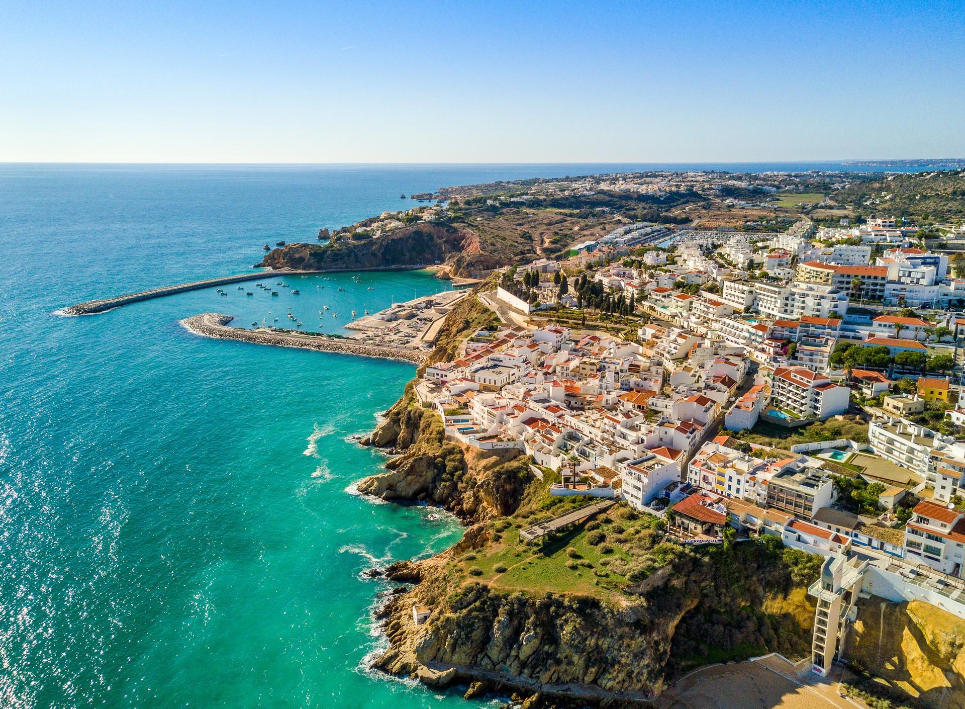 Beach with turquise water in Albufeira on a clear sky day