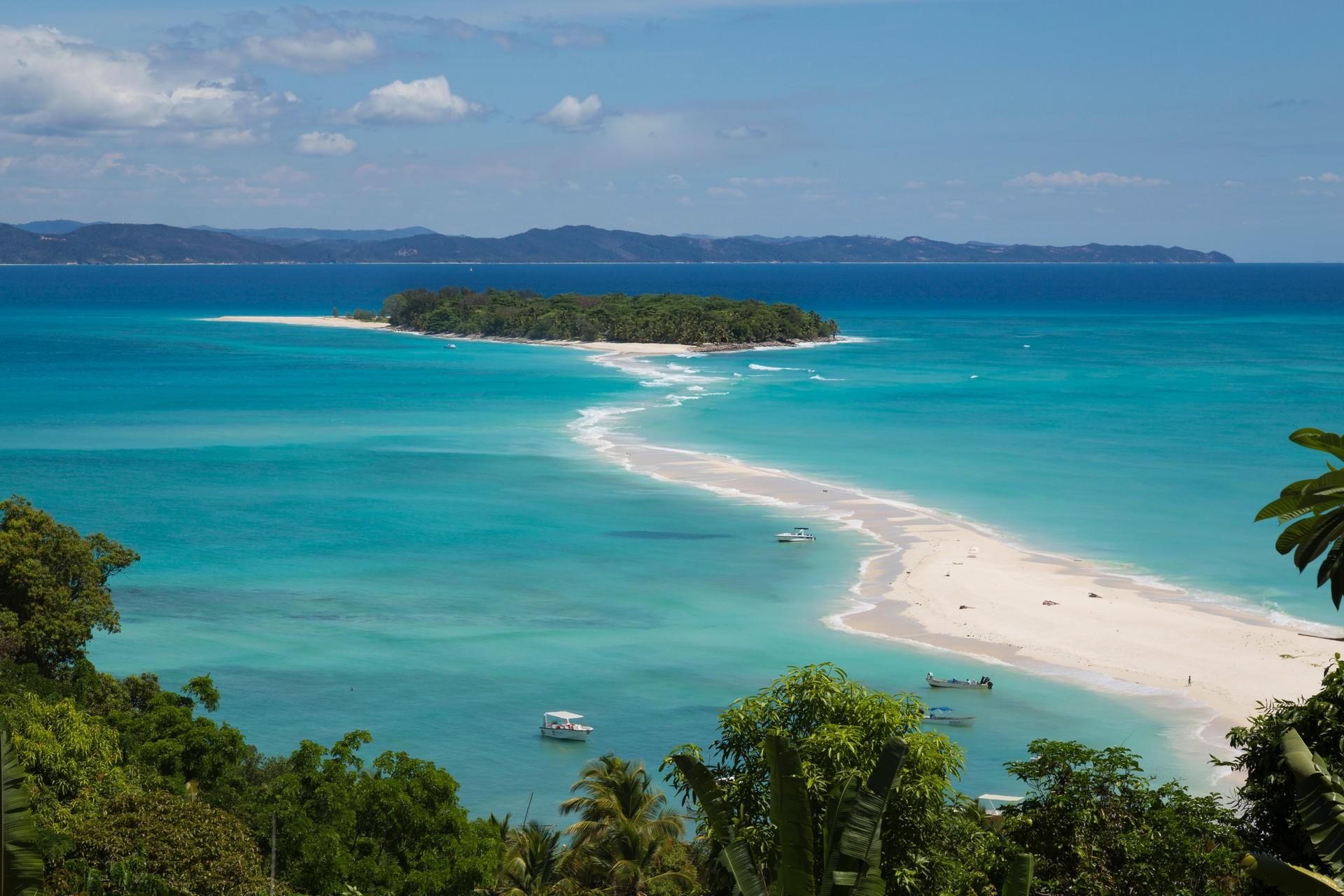 Aerial view of beach in Nosy Be in sunny weather with few clouds