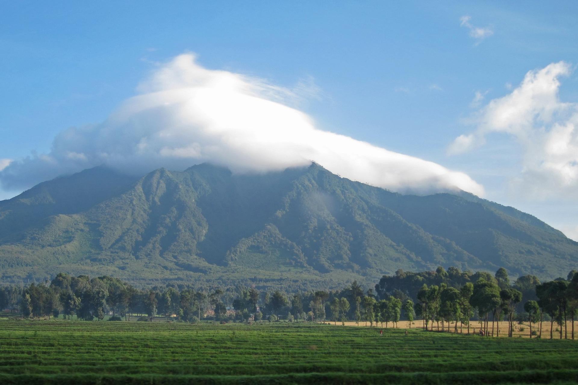 Mountain range in Parc National des Volcans on a sunny day with some clouds