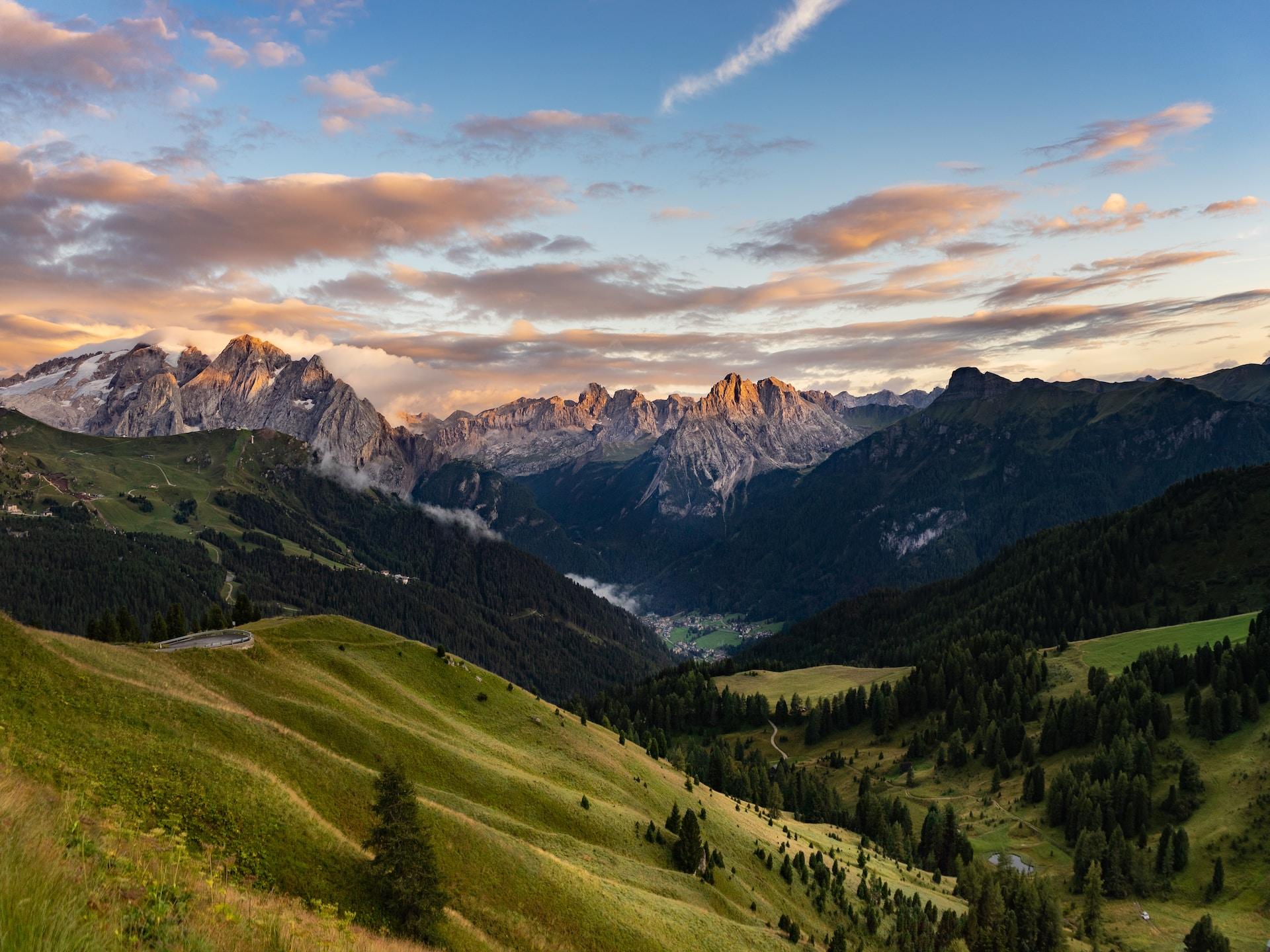 Italy, South Tyrol, Passo Sella: mountains and valley at sunset.