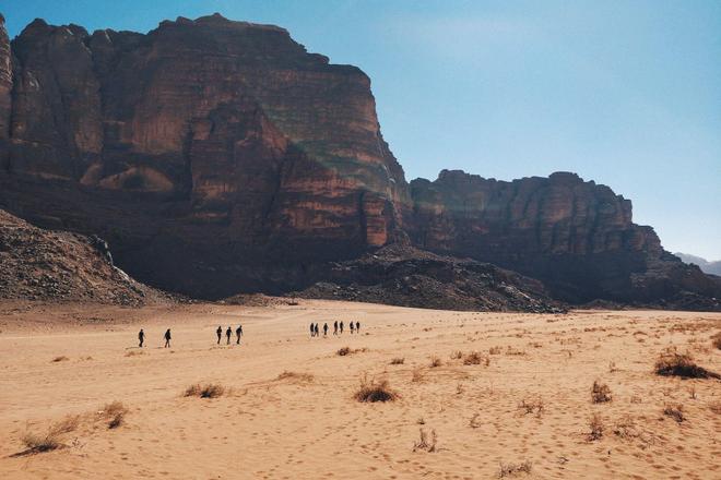 View of mountains and people walking in a desert in Jordan