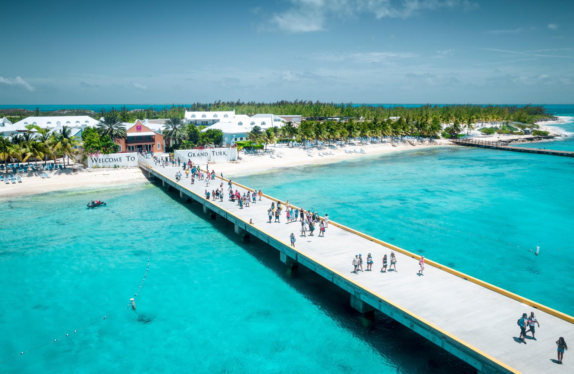 Nice beach by the sea with turquise water in Turks and Caicos Islands in sunny weather with few clouds