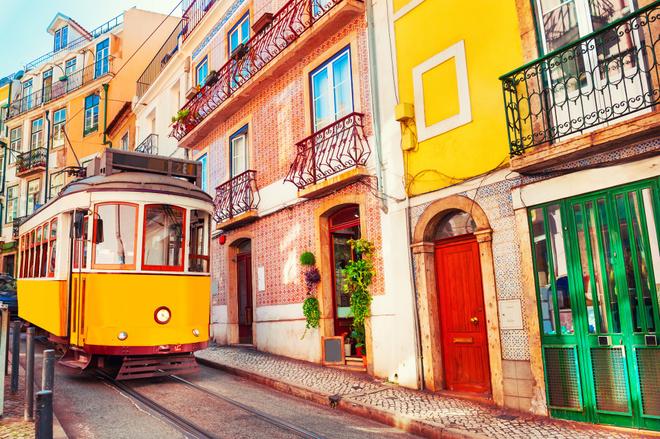 Typical yellow elevator on the colourful street of Lisbon.