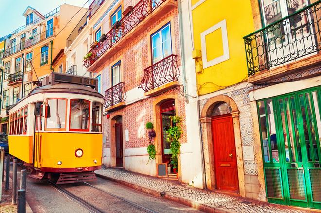 Typical yellow elevator on the colourful street of Lisbon.