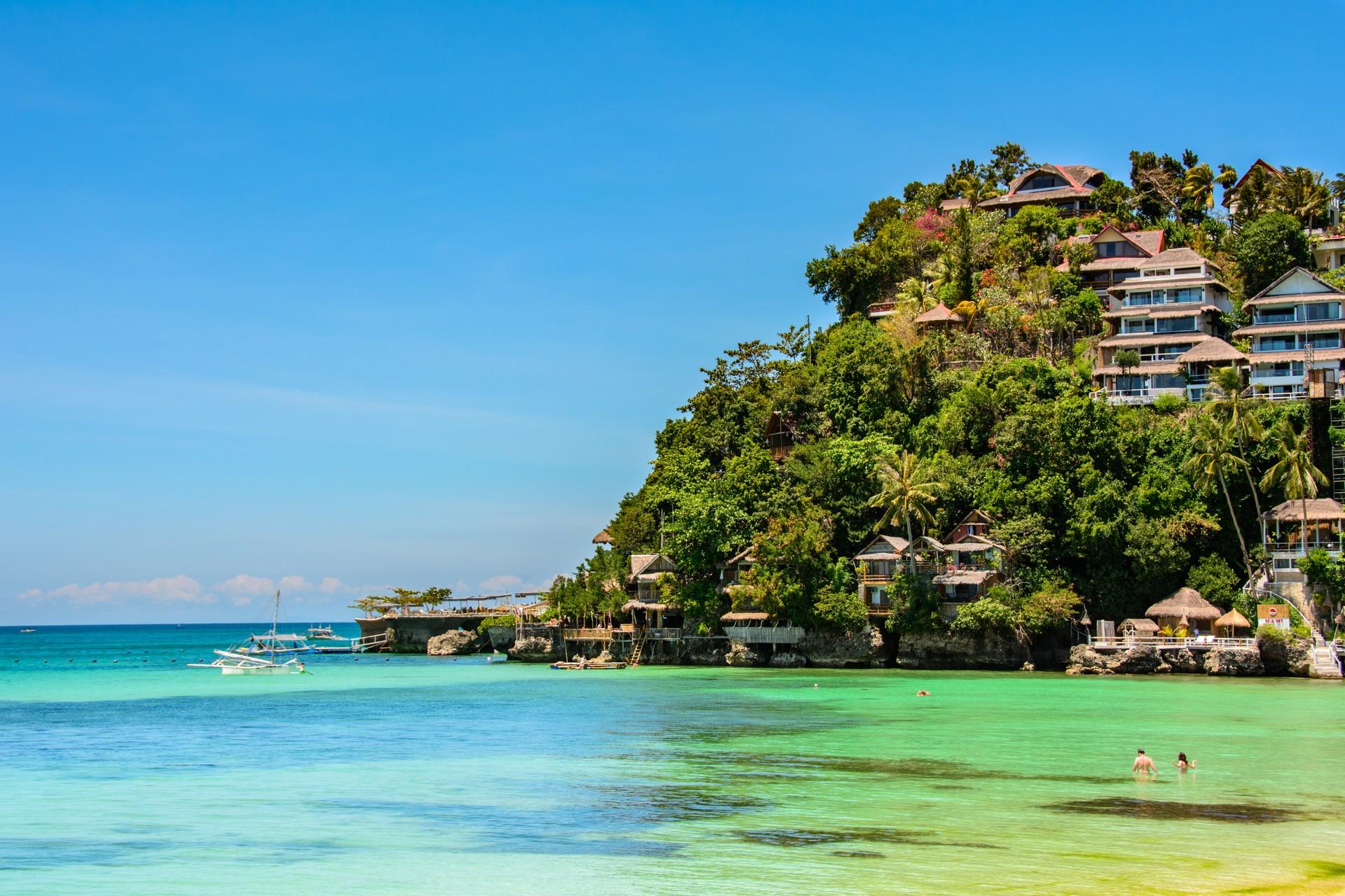 Beach with turquise water in Boracay on a sunny day with some clouds