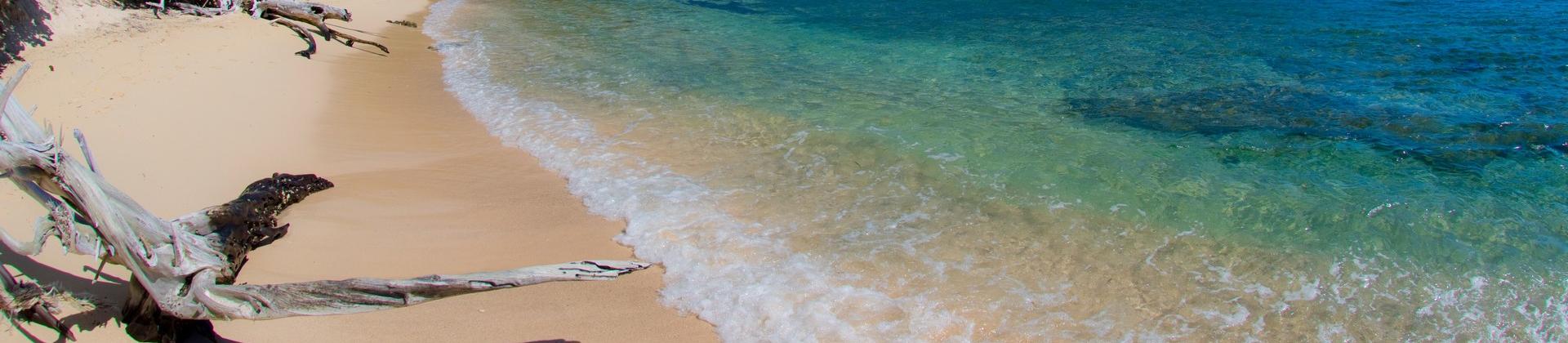 Beach with turquise sea near Saint John in sunny weather with few clouds
