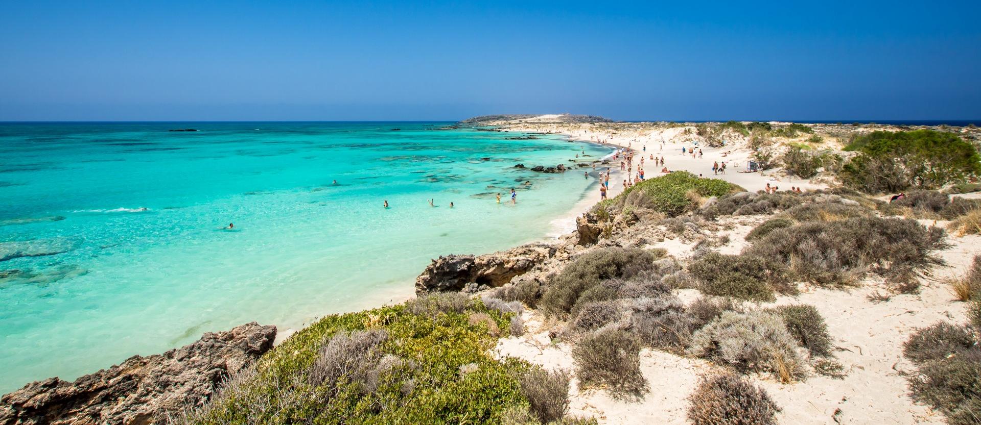 Nice beach by the sea with turquise water in Crete on a clear sky day