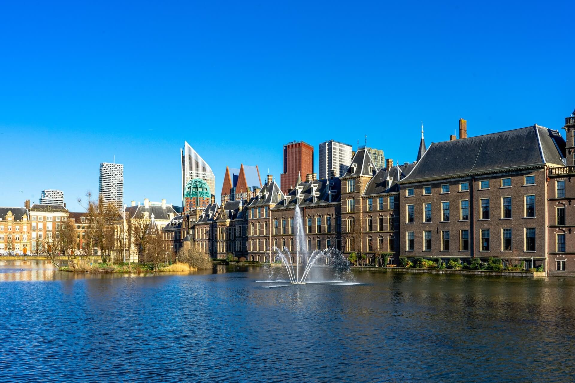 View of sea, fountain and buildings in the background