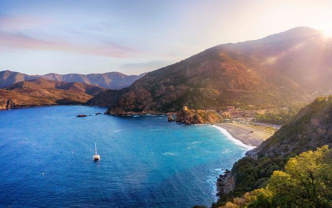 Mountainous and wild Corsican coast with beach.