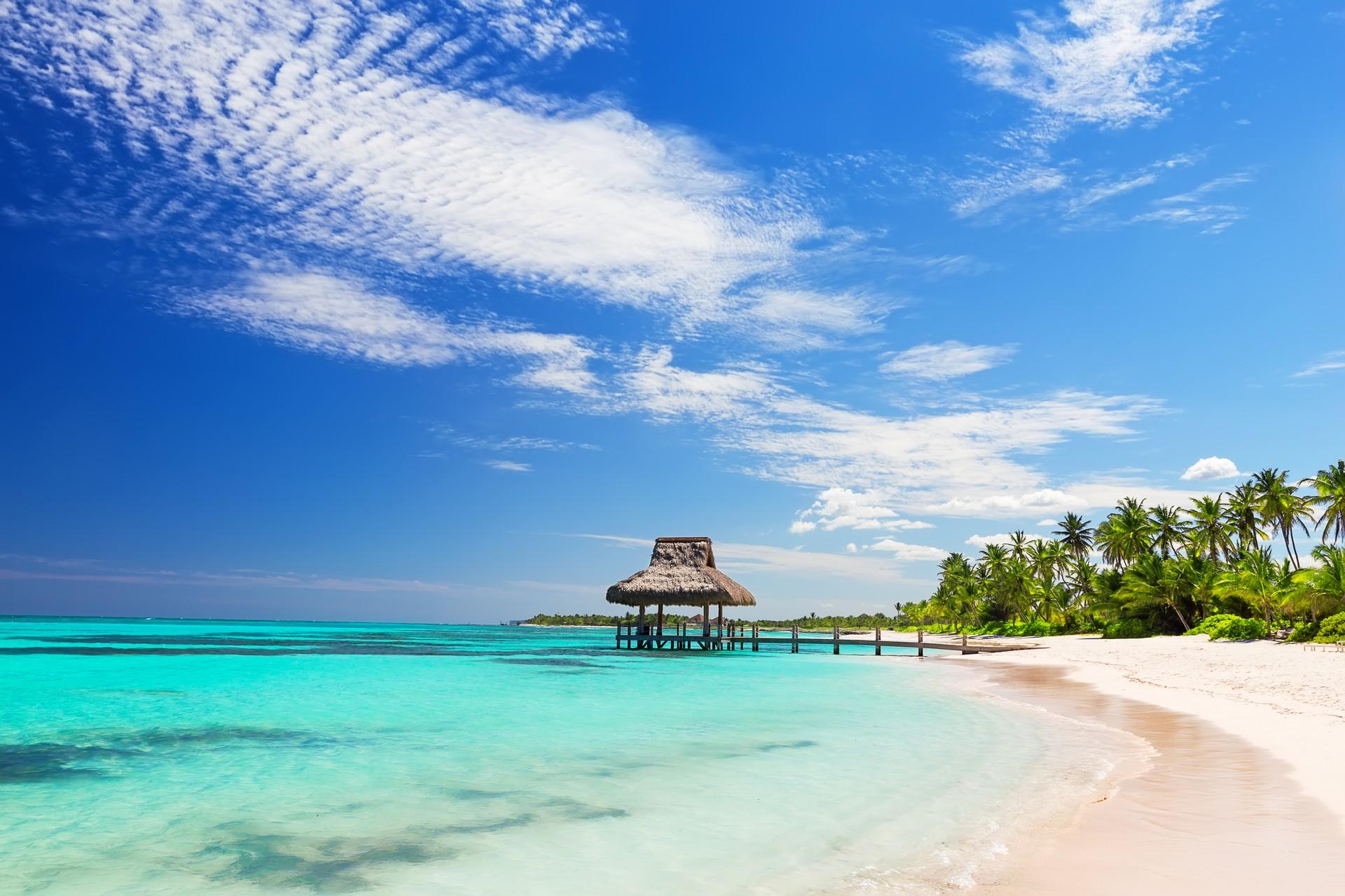 Enjoyable beach with turquise water in Punta Cana on a sunny day with some clouds