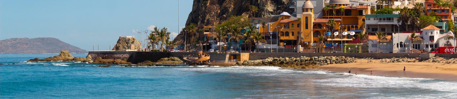 Beach and architecture in Mazatlán in partly cloudy weather