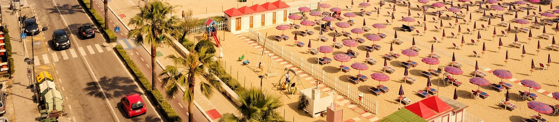 Beach with a lot of people and architecture in Montesilvano in partly cloudy weather