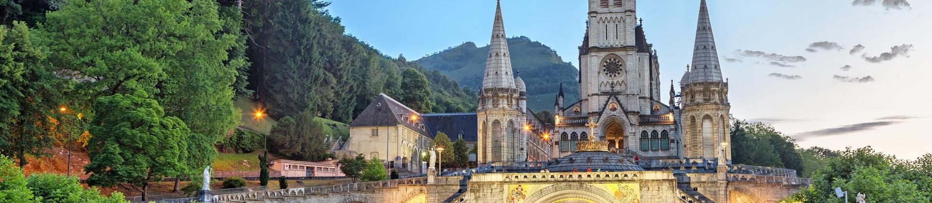 City square in Lourdes in sunny weather with few clouds