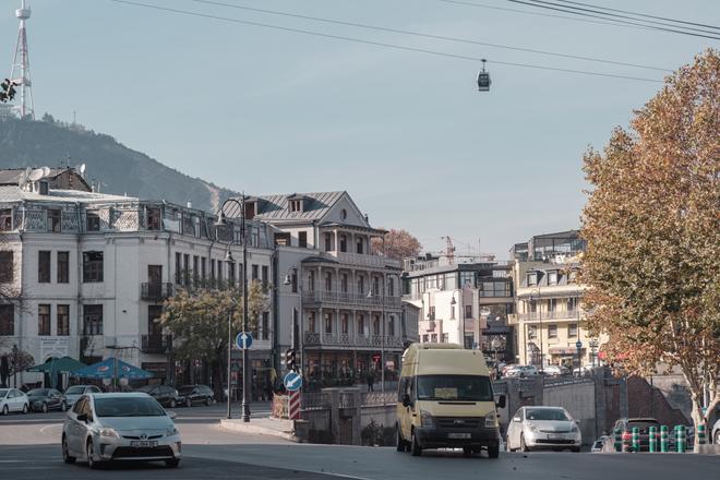 Tbilisi: cable car over the city street with cars,
