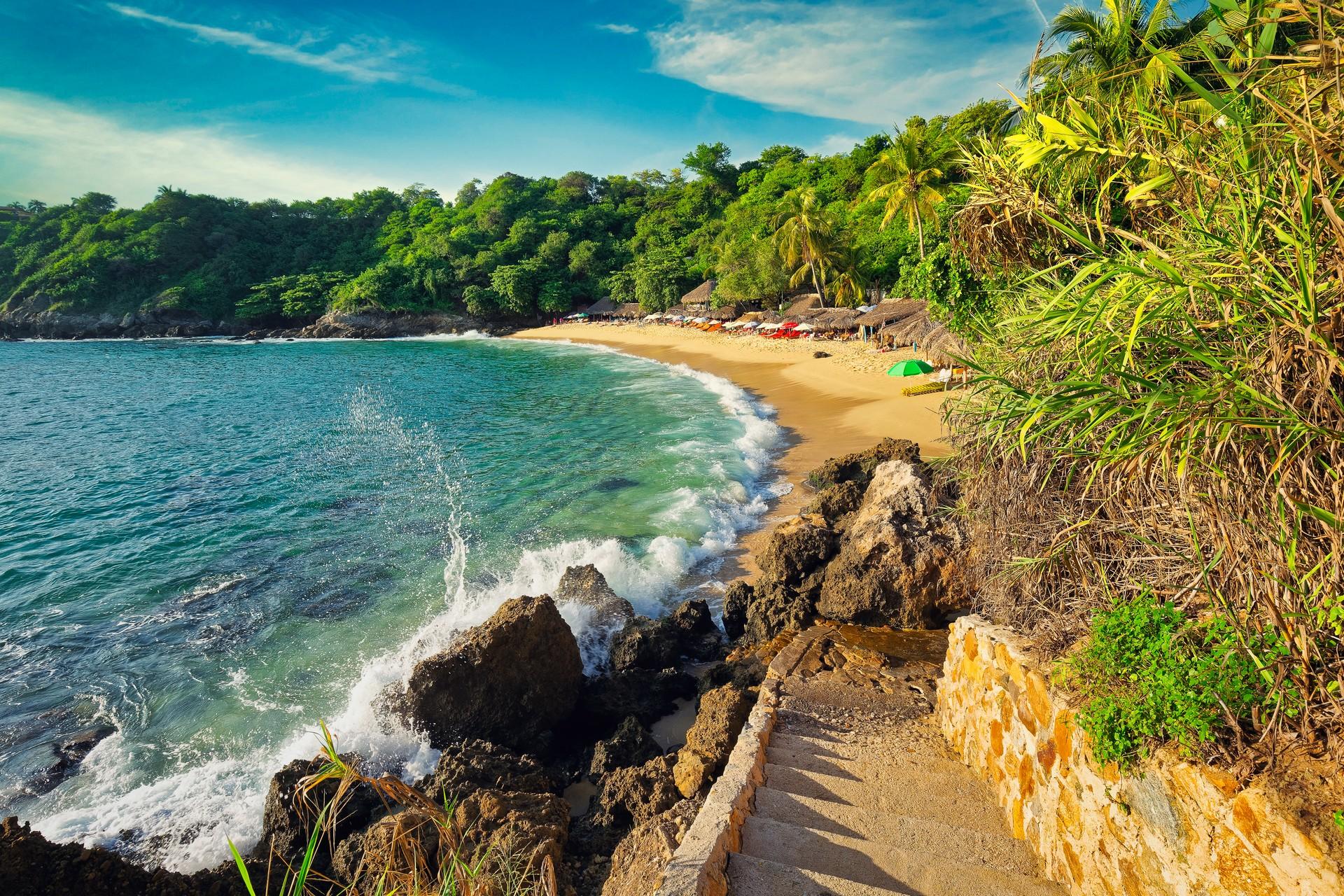 Beach in Puerto Escondido on a sunny day with some clouds