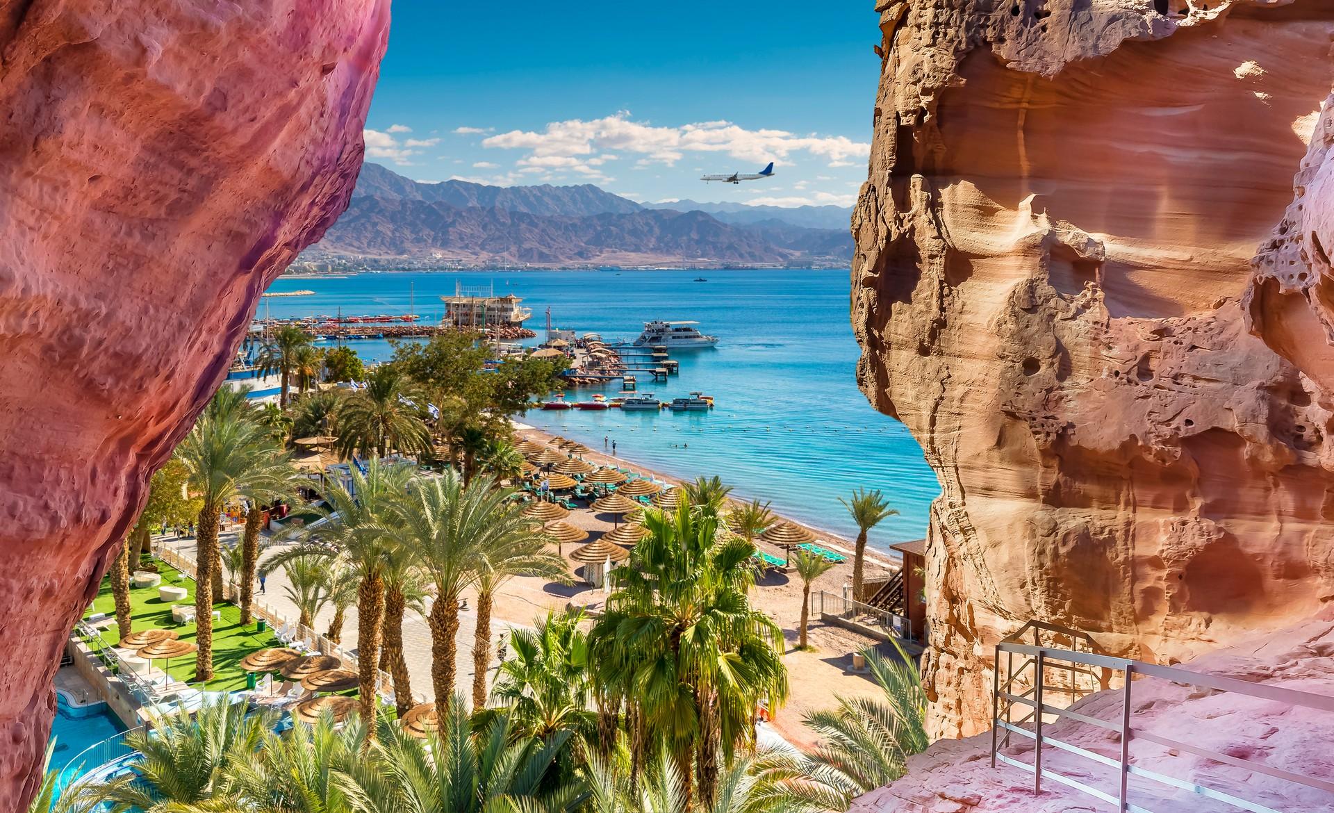 Beach and mountain range in Eilat in partly cloudy weather