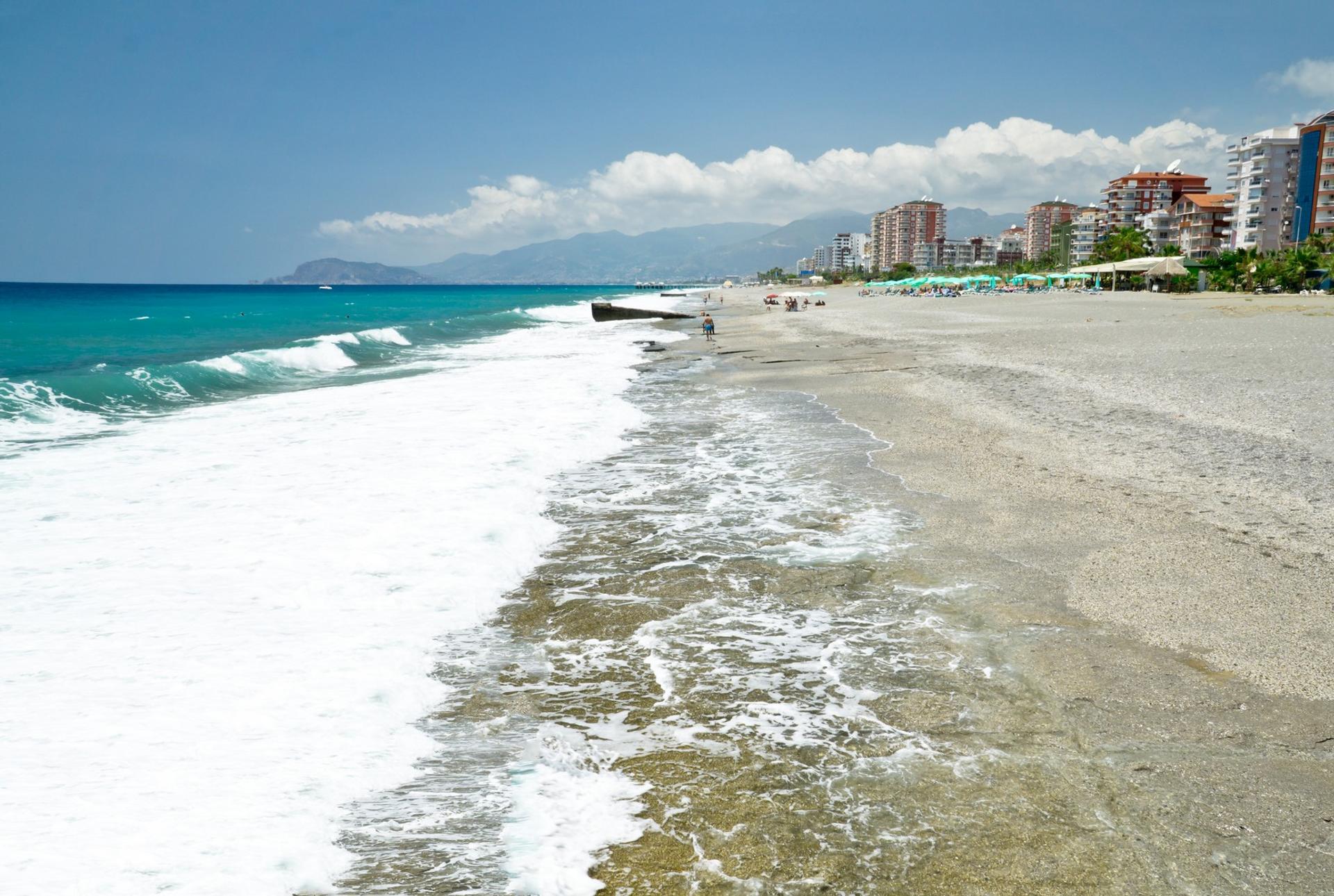 Beach and boat in Mahmutlar on a sunny day with some clouds