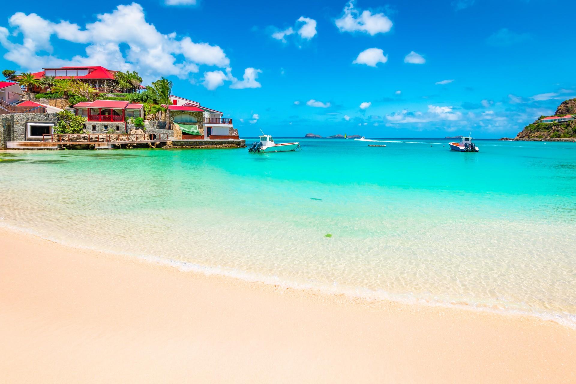 Enjoyable beach with turquise water in Saint Barthélemy on a sunny day with some clouds