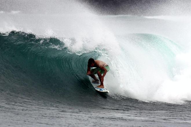 A man surfing a wave in the sea