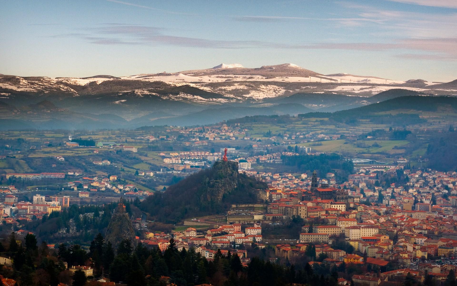 Aerial view of mountain range in Le Puy-en-Velay in sunny weather with few clouds