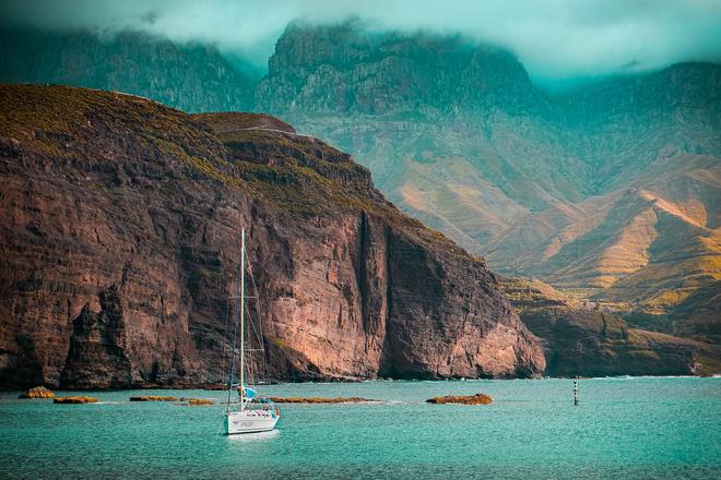 Gran Canaria: sailing ship at sea with reefs in the background.