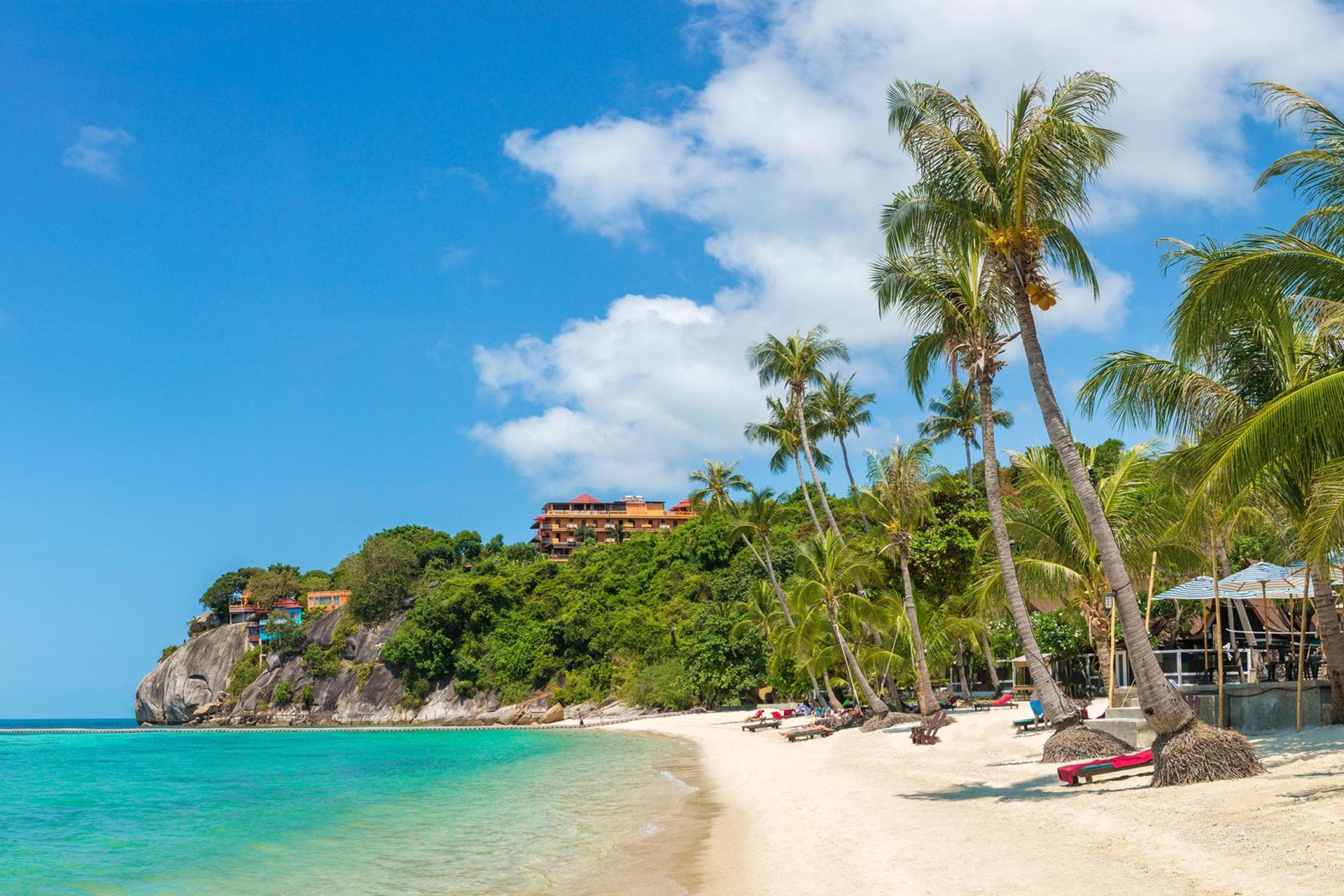 Nice beach by the sea with turquise water in Koh Phangan in sunny weather with few clouds