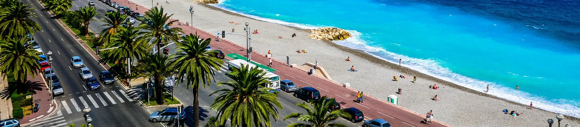 Beach with turquise water in Nice on a sunny day with some clouds