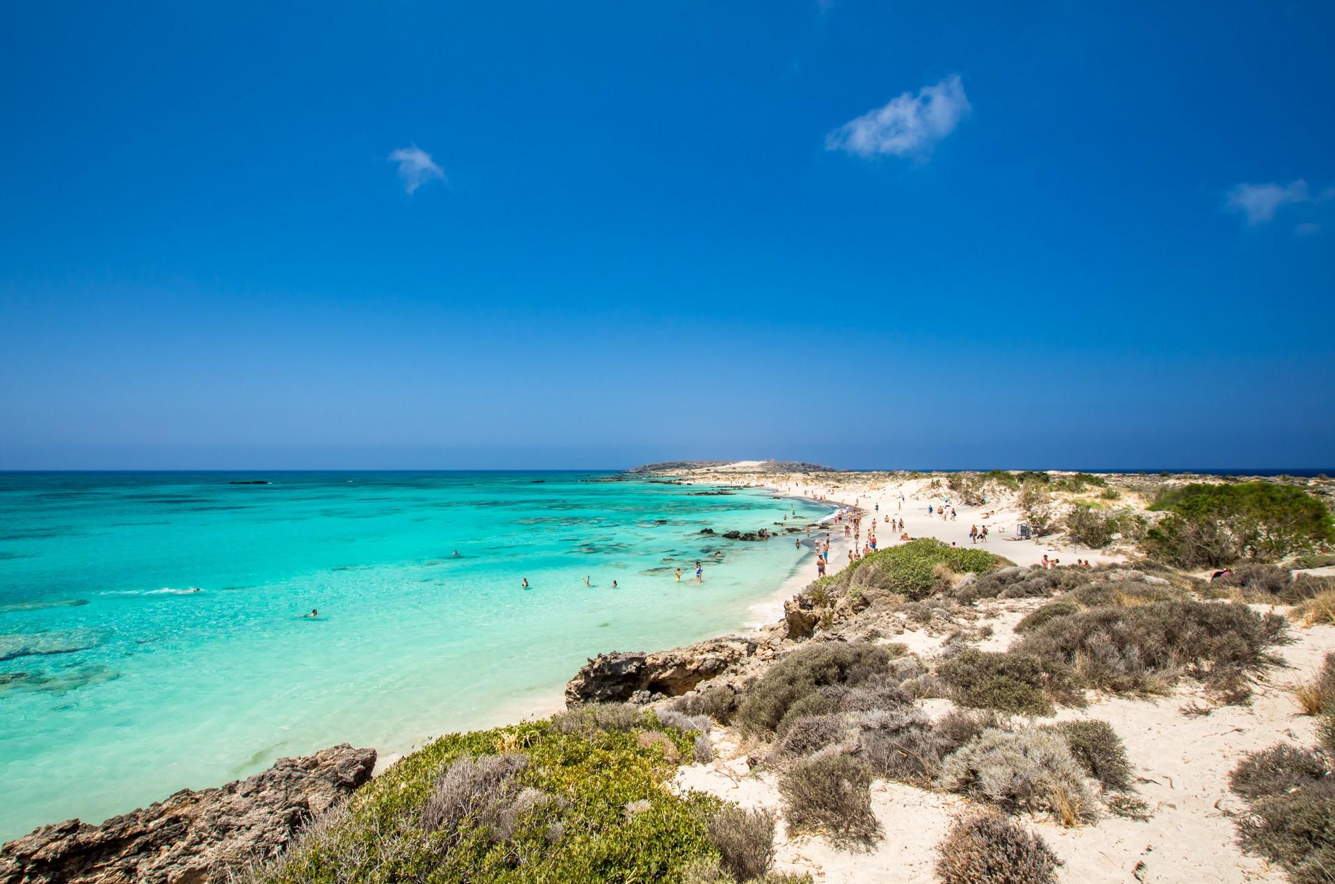 Nice beach by the sea with turquise water in Crete on a clear sky day