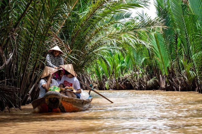 People cruising on the Mekong Delta river in Vietnam