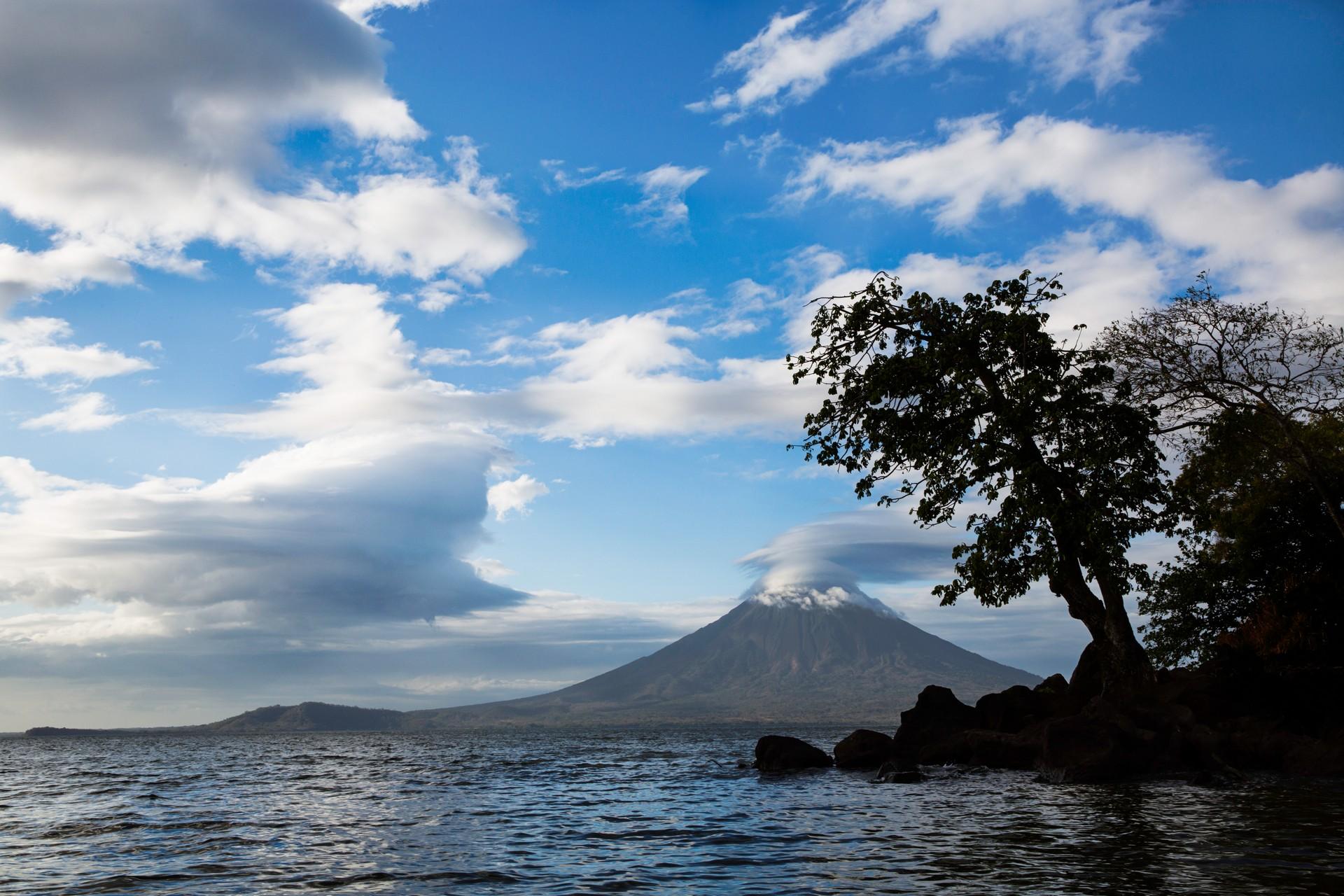 Beach and mountain range in Ometepe in sunny weather with few clouds